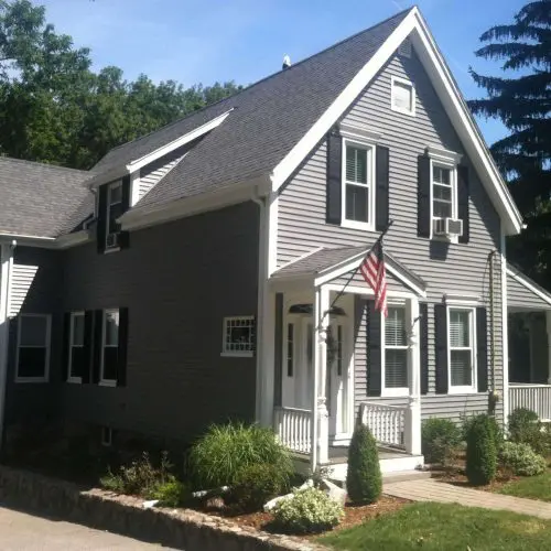 A completed siding project featuring grey vinyl siding.