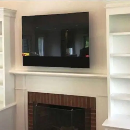 Liberty Painting, living room carpentry project featuring built in bookcases and fireplace mantle.