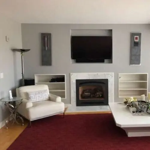 A completed interior painting project done in a light grey living room.