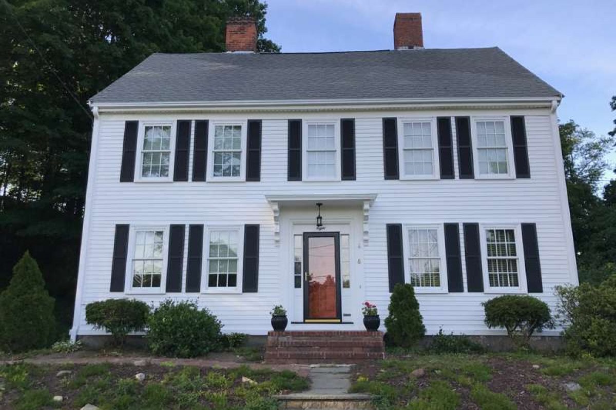 A photo of a colonial home after the exterior has been updated by Liberty Painting.