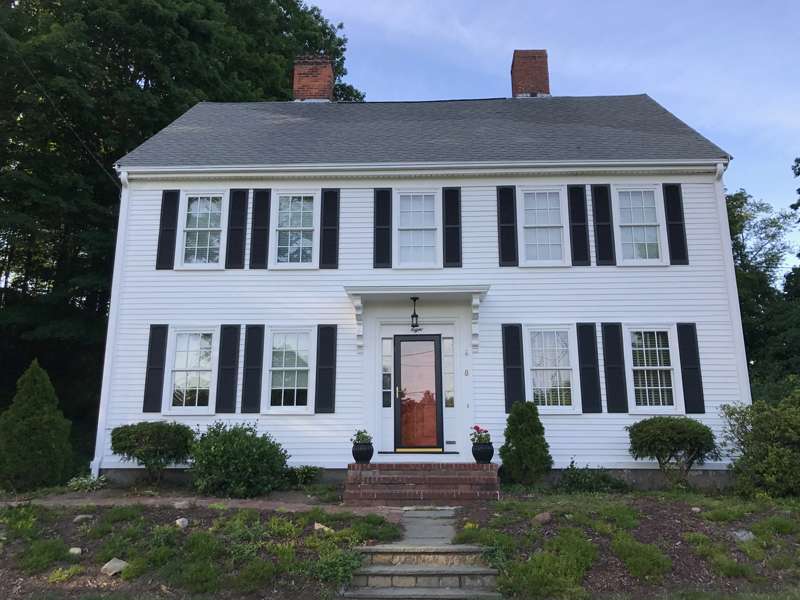 A photo of a colonial home after the exterior has been updated by Liberty Painting.