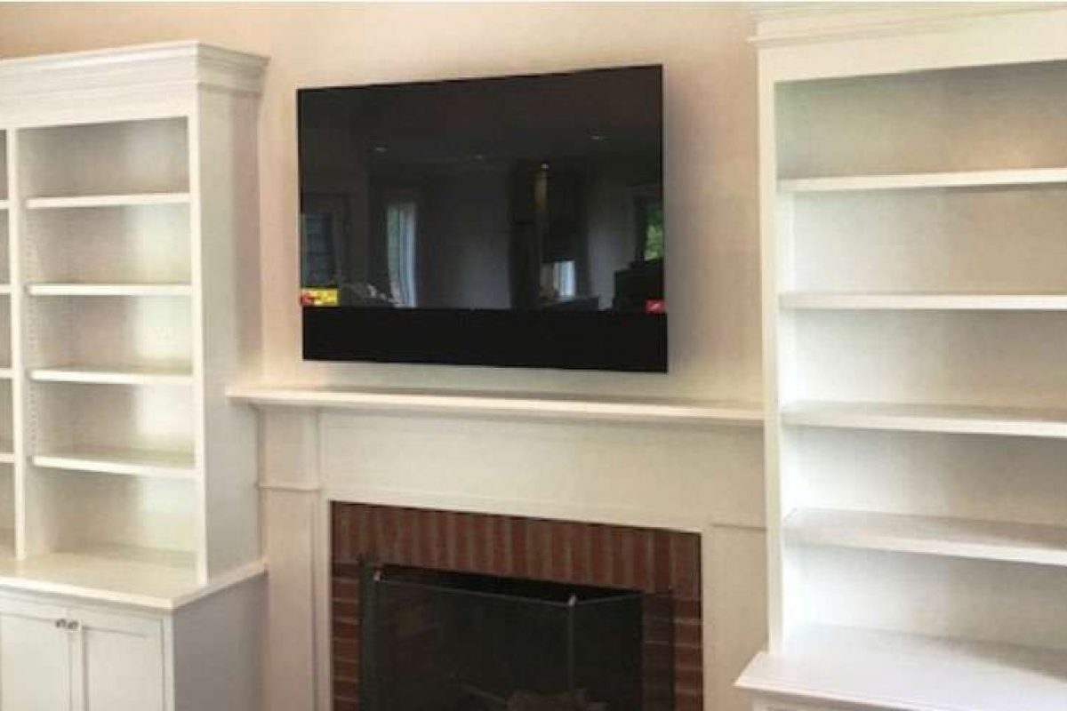Liberty Painting, living room carpentry project featuring built in bookcases and fireplace mantle.