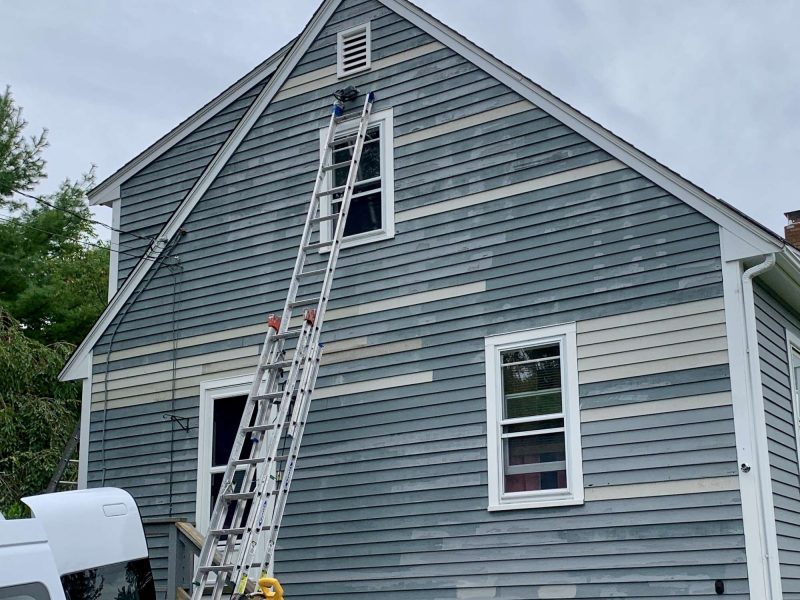 A photo taken during a project updating the clapboards on a house.