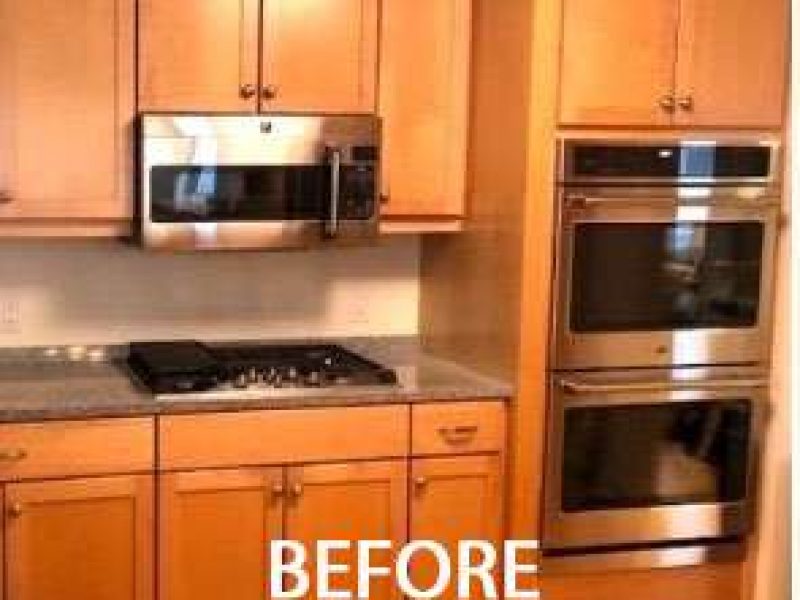 A before photo of an outdated kitchen with lighter wood cabinets.