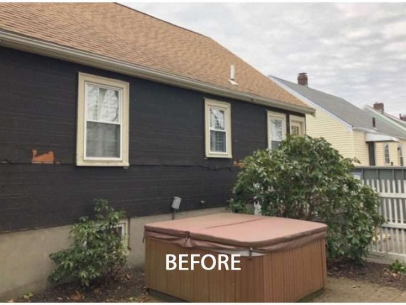 A before photo of a Liberty Painting project where the back siding of a home in West Quincy needed to badly be repaired.