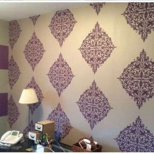 A photo of a home office. Liberty Painting updated the wall coverings using purple and white pattern wallpaper.