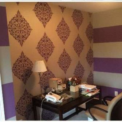 Another photo of a home office. Liberty Painting updated the wall coverings using purple and white pattern wallpaper.