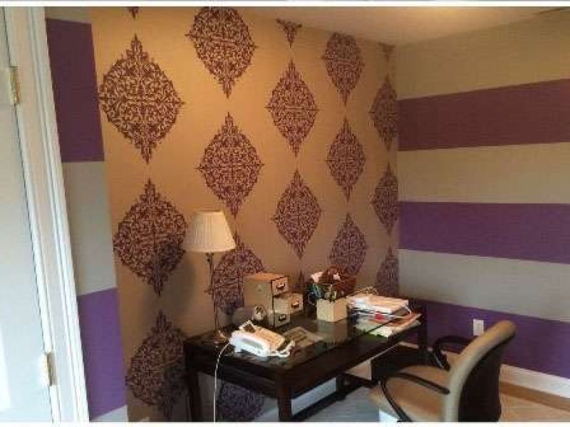 Another photo of a home office. Liberty Painting updated the wall coverings using purple and white pattern wallpaper.