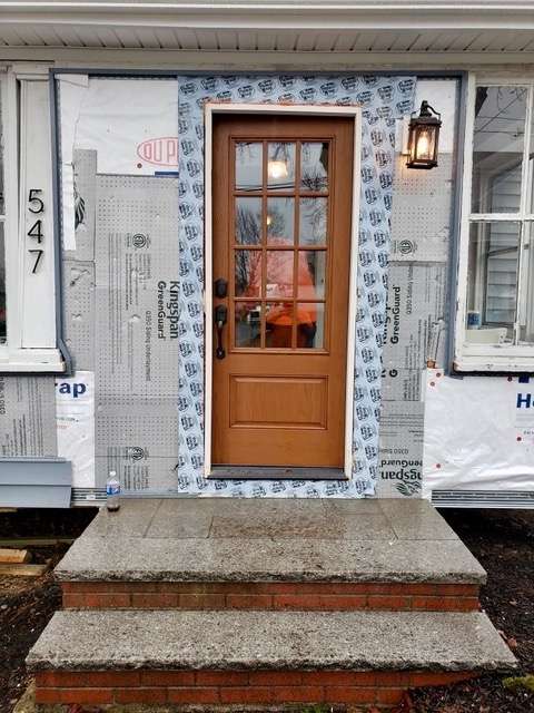 A photo taken during the door installation of a new door in Canton, MA by Liberty Painting.