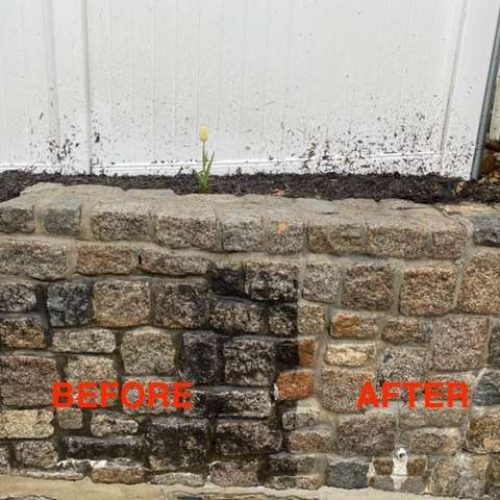 Before and after photo showing the difference on a garden stone wall with Liberty Painting's expert power-washing service. One side is caked in dirt while the other looks squeaky clean.